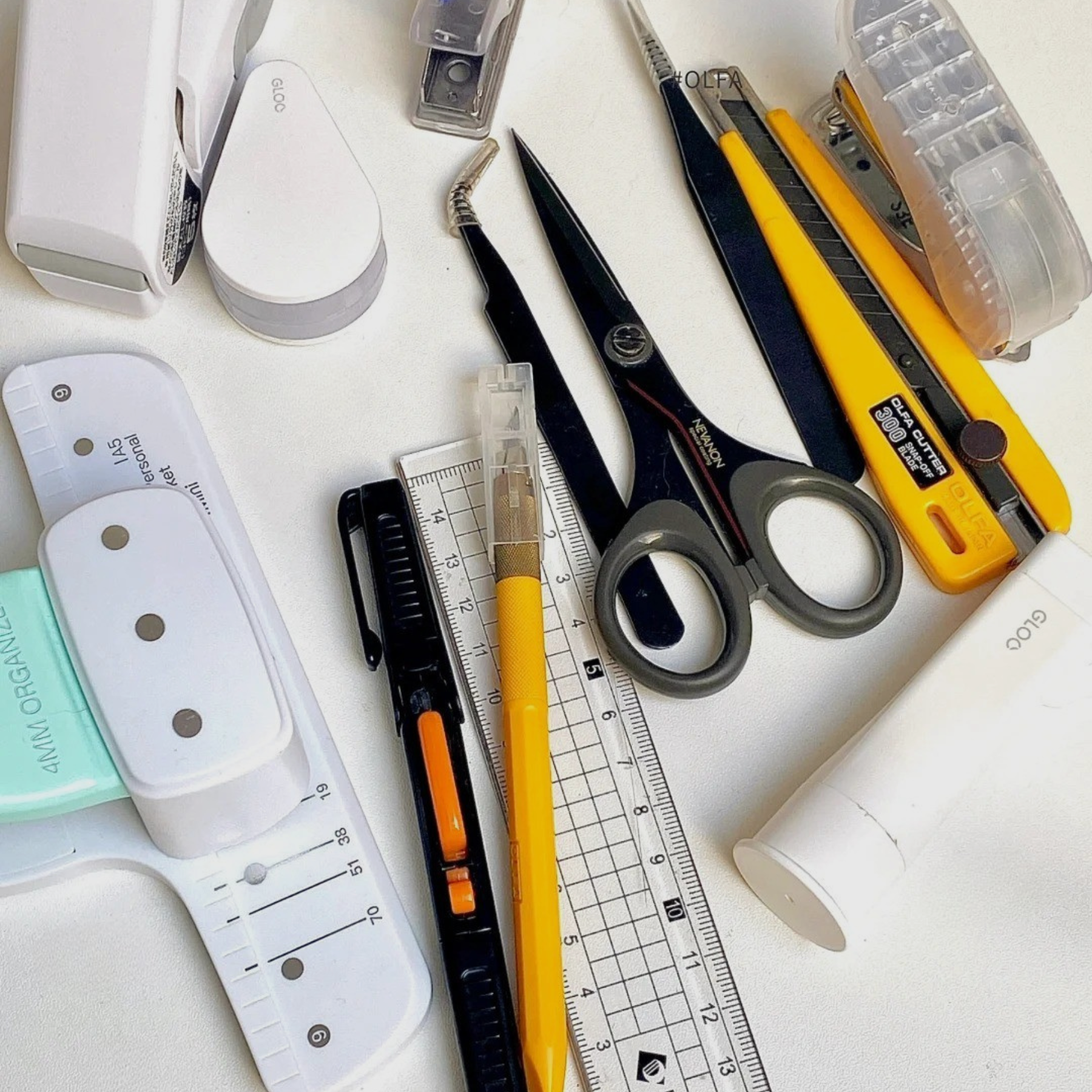 Journaling tools including scissors, adhesives, stencils, and more.